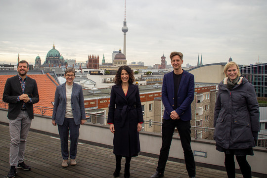 Die Landesvorsitzenden und die neuen Senator*innen der Grünen Berlin stehen auf einem Dach, im Hintergrund ein Berlin-Panorama. Bündnis 90/Die Grünen Berlin